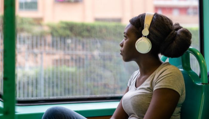 girl enjoying music on the bus 