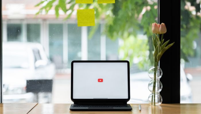 youtube logo on laptop and background with tree